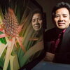 man by computer screen showing a pineapple