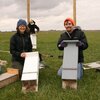 Joy O'Keefe (left) and Reed Crawford (right) with bat boxes installed for a previous study.