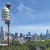 A device on a pole with the skyline of Chicago in the background