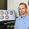 A headshot of professor Csaba Varga next to a chart