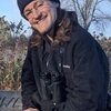 A photo of Mac Chamberlain sitting on a bench outside