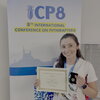 A photo of a student holding her award in front of a poster