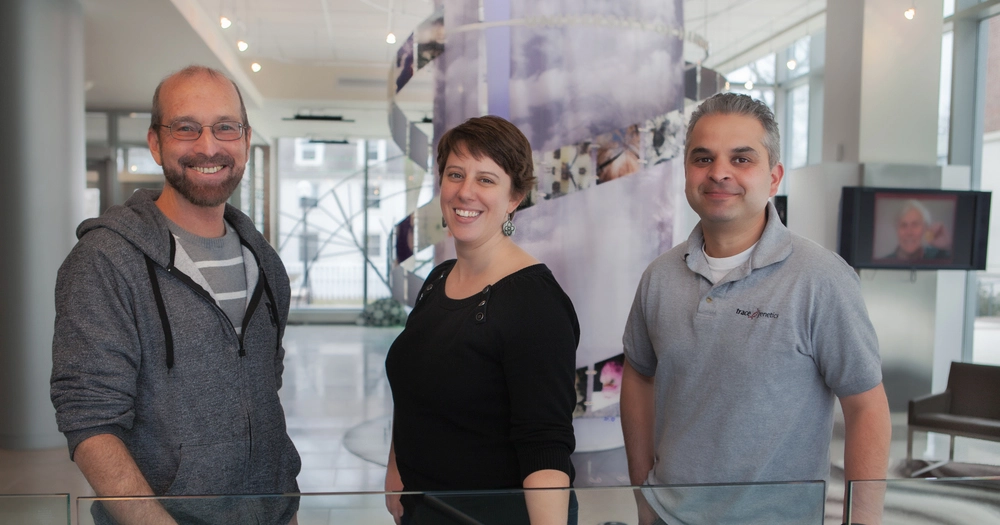 three smiling people