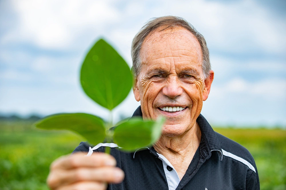 A photo of Stephen Long holding a plant