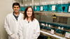 two smiling people in lab coats