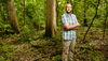 man smiling in woods