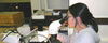 woman looking into a microscope
