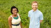 two smiling people at a field