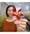 A photo of Minya holding a flower
