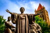 A statue with a blue sky in the backgrounds