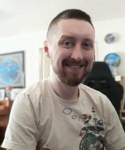 A smiling man in a t-shirt smiling