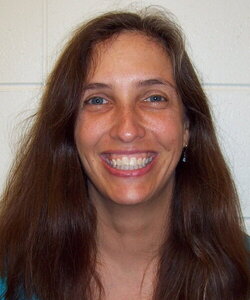 A smiling woman with long brown hair