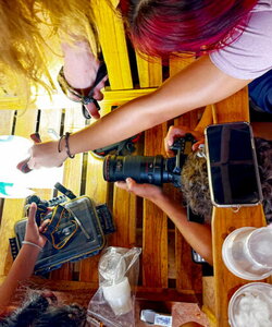 A top down view of people working in a wooden room