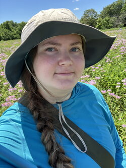 A photo of Annaliese Wargin standing in a field of flowers