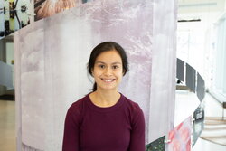 A photo of Michelle Zambrano standing in front of an art fixture