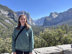 A photo of Meghan Blaszynski standing in front of some mountains