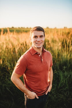 A photo of Nicholas Morphew standing next to a field