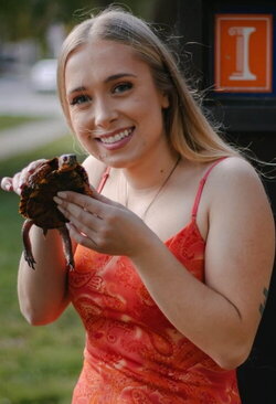A photo of Abby Webber holding a turtle