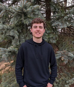 a photo of Ben Brosnan standing in the woods