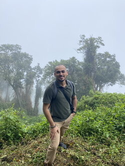 A photo of Francisco Cornejo standing in a rainforest