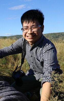 A photo of Wilfred Tang in a field