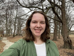 A photo of Megan O'Sullivan out on a trail in the woods