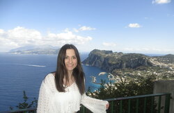 A photo of Mia Possin with a back drop of a lake behind her