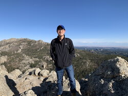 A photo of Vincent Prayugo standing on a mountain top