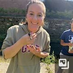 A photo of Sarah Rodriguez holding an animal