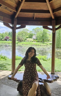Valeria Ocampo sitting under a gazebo near a pond