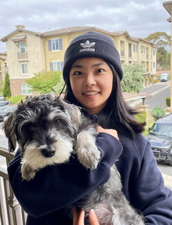 A photo of Yuchen Wang holding a dog
