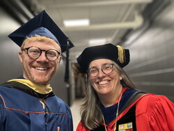 A selfie of Eric and Carla Cáceres together in graduation garb